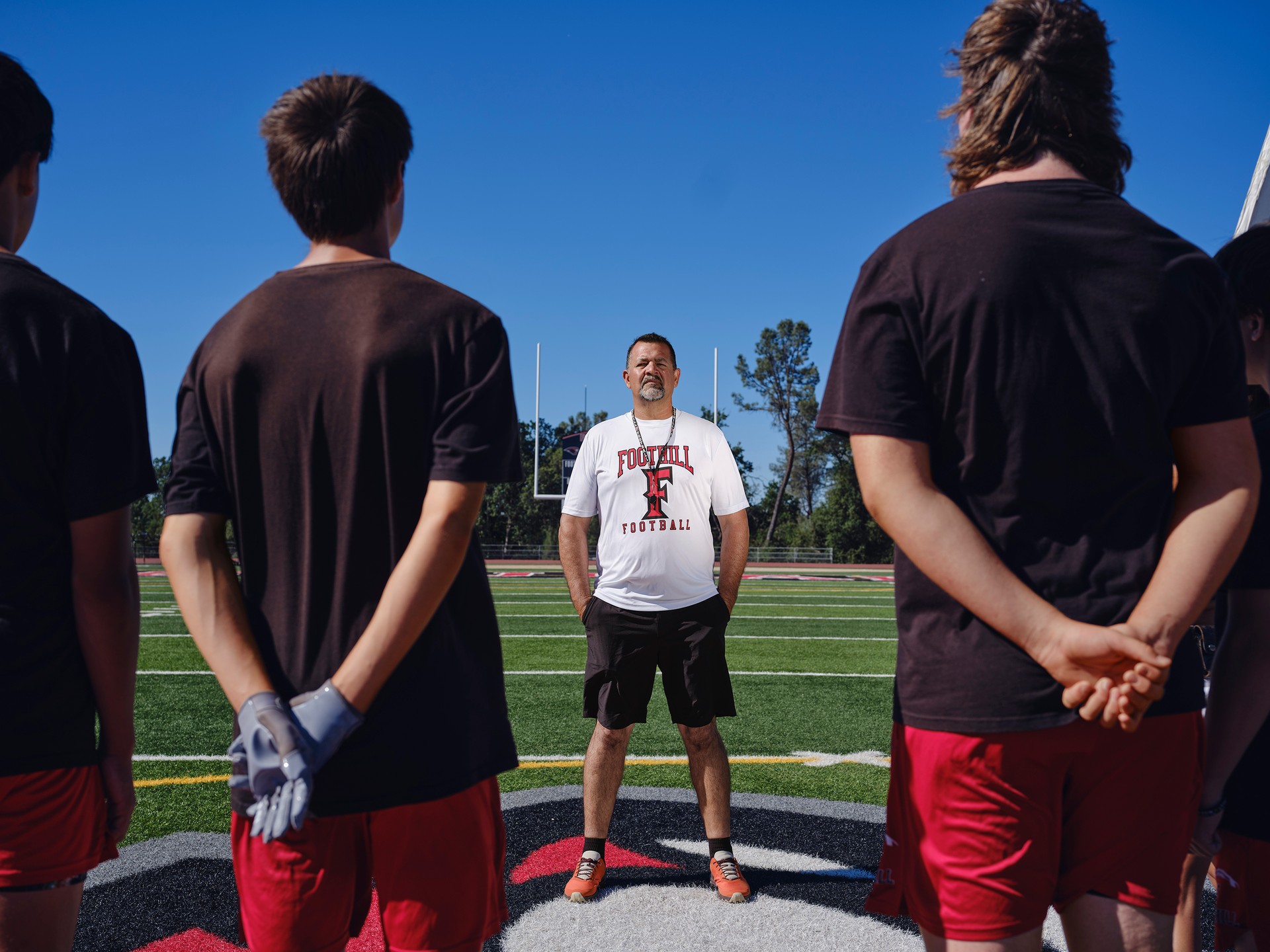 Coach Sanchez standing in front of his young players to talk about vaping